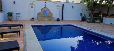 a blue swimming pool in front of a building at casa de vicky in El Puerto de Santa María