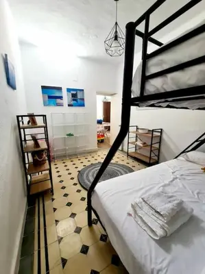 a bedroom with a bunk bed and a tiled floor at P Casa con Azotea privada y Céntrica. WiFi+Netflix in El Puerto de Santa María
