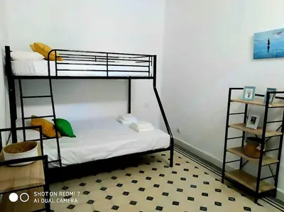a bedroom with two bunk beds and a floor at P Casa con Azotea privada y Céntrica. WiFi+Netflix in El Puerto de Santa María