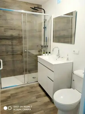 a bathroom with a shower and a toilet and a sink at P Casa con Azotea privada y Céntrica. WiFi+Netflix in El Puerto de Santa María