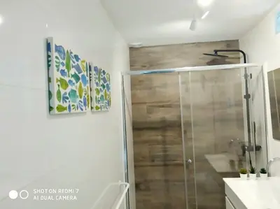 a shower with a glass door in a bathroom at P Casa con Azotea privada y Céntrica. WiFi+Netflix in El Puerto de Santa María
