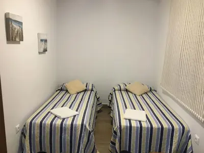 two beds sitting next to each other in a room at Moderno apartamento en Bahia Sur in San Fernando