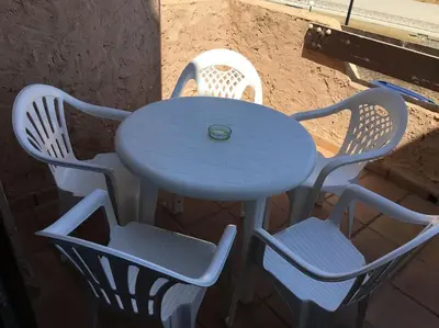 a table and four chairs with a blue table and chairs at Moderno apartamento en Bahia Sur in San Fernando