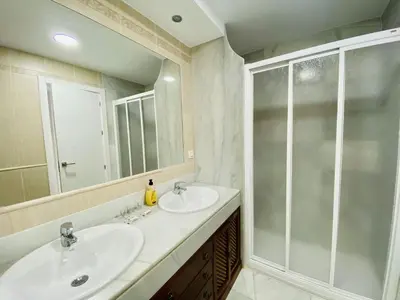 a bathroom with two sinks and a shower at Botánico Playa y Ascensor Grupo AC Gestion in Cádiz