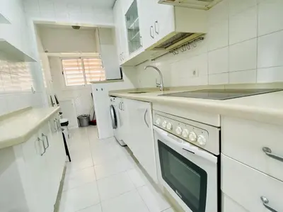 a white kitchen with a sink and a dishwasher at Botánico Playa y Ascensor Grupo AC Gestion in Cádiz