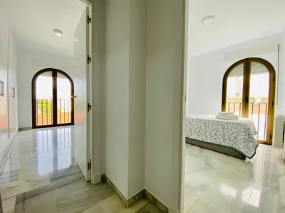 a bedroom with a bed in the middle of a room at Botánico Playa y Ascensor Grupo AC Gestion in Cádiz
