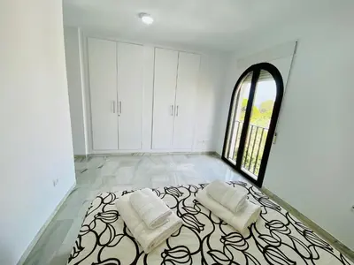 a room with a bed with white walls and a window at Botánico Playa y Ascensor Grupo AC Gestion in Cádiz