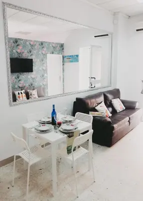 a living room with a table and a couch at Miriam Costa de la luz 2 in Jerez de la Frontera