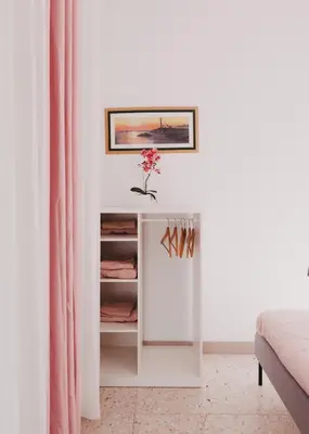 a white cabinet with a vase of flowers on top at Miriam Costa de la luz 2 in Jerez de la Frontera