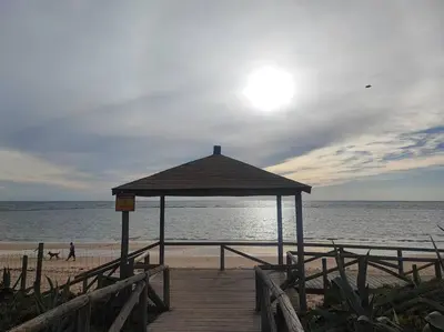 a gazebo on a beach with the ocean at Precioso bajo muy grande a 200 metros de playa in Chipiona
