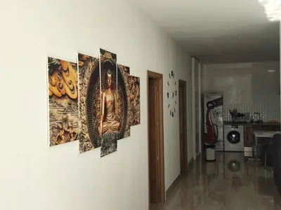 four paintings hanging on a wall in a living room at Precioso bajo muy grande a 200 metros de playa in Chipiona