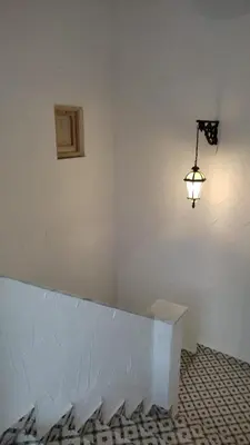 a room with a white wall with a light on it at Apartamento la Buganvilla in Jerez de la Frontera