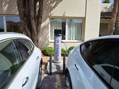 a car is parked next to a parking meter at Vincci Resort Costa Golf in Chiclana de la Frontera