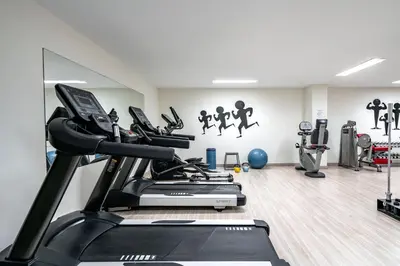 a gym with treadmills and a treadmill at Vincci Resort Costa Golf in Chiclana de la Frontera