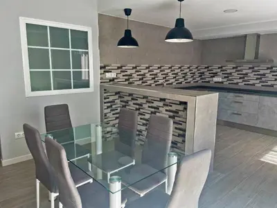 a dining room with a glass table and chairs at Apartamento La Catedral - Ole Solutions in Jerez de la Frontera