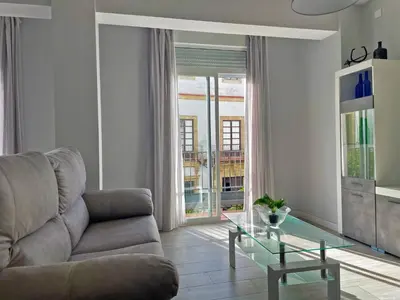 a living room with a couch and a glass table at Apartamento La Catedral - Ole Solutions in Jerez de la Frontera