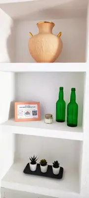 a shelf with three green vases and plants on it at Apartamento Plaza Toros in El Puerto de Santa María