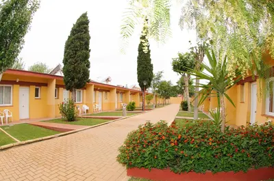 a brick road in front of a yellow building at Hotel Dunas Puerto in El Puerto de Santa María