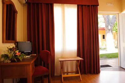 a room with a desk with a computer and a window at Hotel Dunas Puerto in El Puerto de Santa María