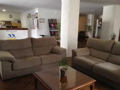 a living room with two couches and a coffee table at Hotel Dunas Puerto in El Puerto de Santa María