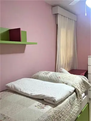 a bedroom with two beds and a window at Piso Calzada de la Infanta Tres Carabelas Sanlúcar de Barrameda in Sanlúcar de Barrameda