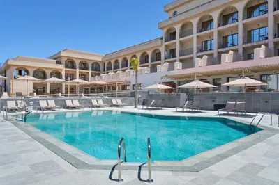 a large swimming pool in front of a building at Hotel Macià Doñana in Sanlúcar de Barrameda