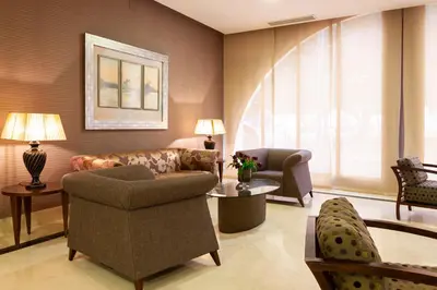 a living room with a couch and a chair at Hotel Macià Doñana in Sanlúcar de Barrameda