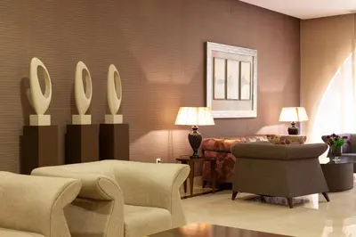 a living room with two chairs and a couch at Hotel Macià Doñana in Sanlúcar de Barrameda