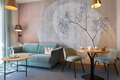 a living room with a couch and two tables at Hotel Macià Doñana in Sanlúcar de Barrameda