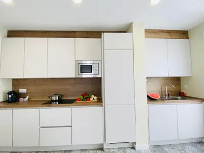 a kitchen with white cabinets and a sink at Summerlandrota Argüelles 4 in Rota