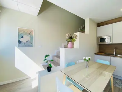 a kitchen and dining room with a table and chairs at Summerlandrota Argüelles 4 in Rota