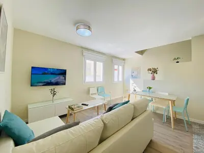 a living room with a couch and a table at Summerlandrota Argüelles 4 in Rota