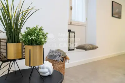 two plants on stands on a table in a living room at Apartamento El Mirador del Paso (Feel Cádiz) in Cádiz