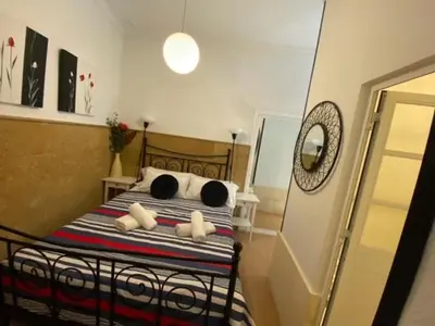 a bedroom with a bed with three pillows on it at EL RINCON DE ELENA (CASCO HISTORICO) in Jerez de la Frontera