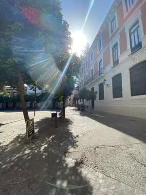a sun shining on a street with a building at EL RINCON DE ELENA (CASCO HISTORICO) in Jerez de la Frontera