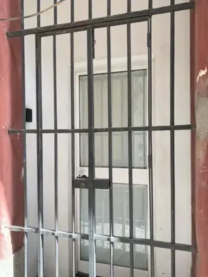 a window with bars on the door of a building at EL RINCON DE ELENA (CASCO HISTORICO) in Jerez de la Frontera