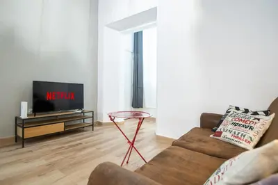a living room with a couch and a tv at El Balcon de la Viña by Cadiz Time in Cádiz
