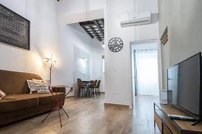 a living room with a couch and a tv at El Balcon de la Viña by Cadiz Time in Cádiz