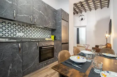 a kitchen with a table and a dining room at El Balcon de la Viña by Cadiz Time in Cádiz