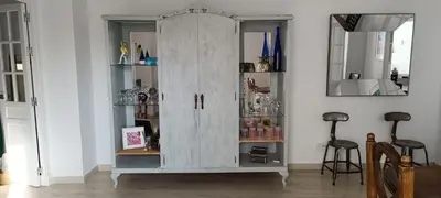 a white cabinet with glass doors in a room at Ático en La Candelaria in Cádiz