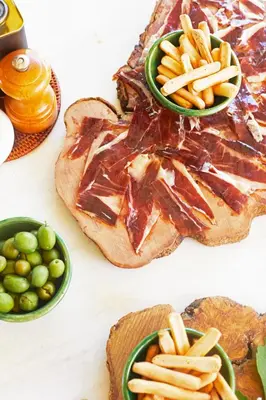 a table topped with plates of food with fries and bread at Hacienda de San Rafael in Las Cabezas de San Juan