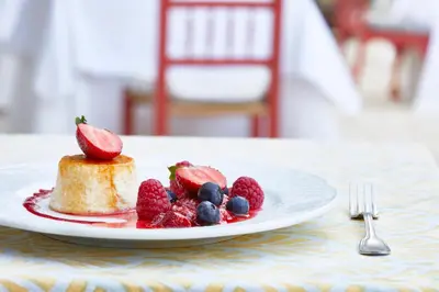 a plate of food with strawberries and berries on a table at Hacienda de San Rafael in Las Cabezas de San Juan