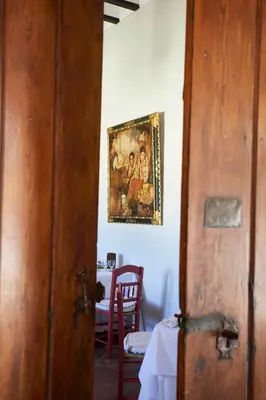 a room with a table and a painting on the wall at Hacienda de San Rafael in Las Cabezas de San Juan