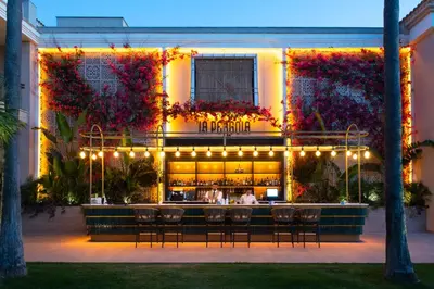 a restaurant with a bar in front of a building at Valentin Sancti Petri in Chiclana de la Frontera