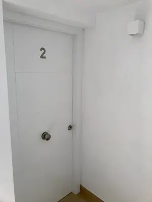 a white door with the number two on it at El rincón de Manolita. #2 in Bornos