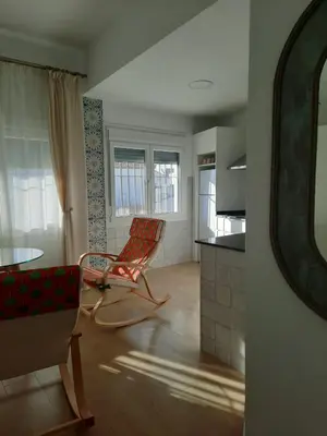 a living room with a chair and a table at El rincón de Manolita. #2 in Bornos