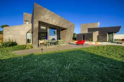 a house on a hill with a lawn in front of it at Retiros Los Agustinos in Arcos de la Frontera