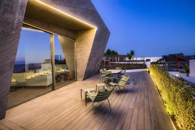a deck with chairs and tables on a building at Retiros Los Agustinos in Arcos de la Frontera