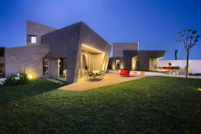 a house with a lawn in front of it at night at Retiros Los Agustinos in Arcos de la Frontera
