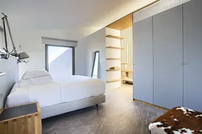 a bedroom with a white bed and a window at Retiros Los Agustinos in Arcos de la Frontera